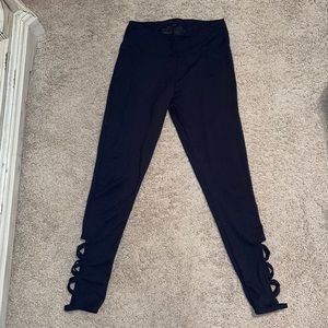 Black Leggings with cris-cross pattern on ankles.